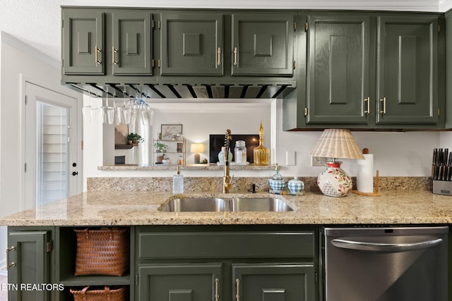 kitchen featuring a sink, crown molding, light stone countertops, stainless steel dishwasher, and green cabinetry