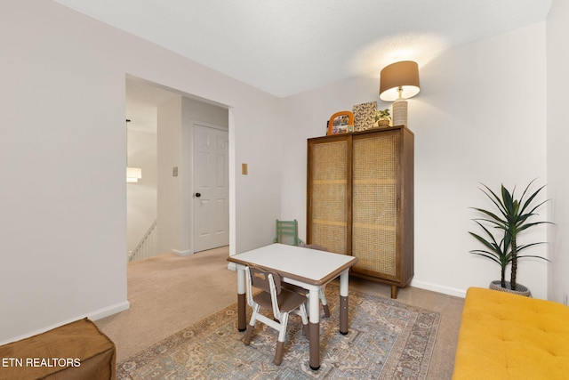 dining room with carpet flooring and baseboards