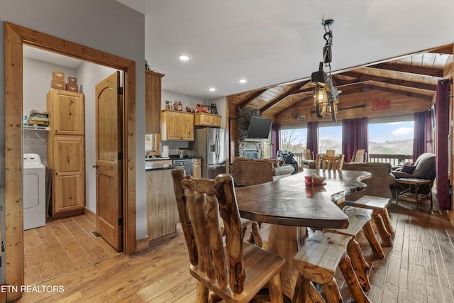 dining space with recessed lighting, washer / clothes dryer, light wood-style flooring, and vaulted ceiling with beams