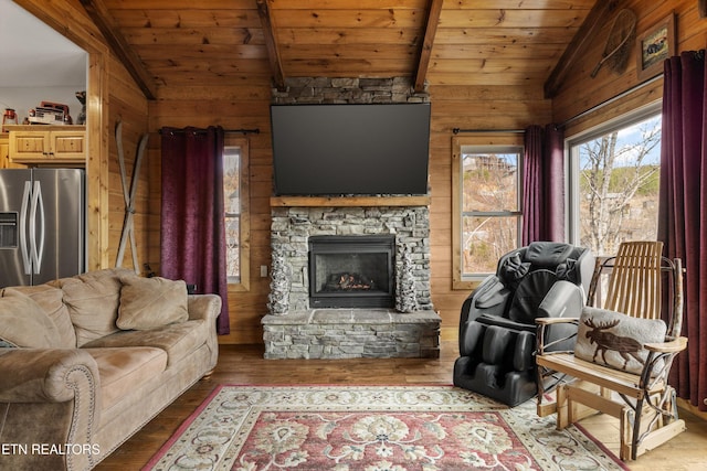 living area with lofted ceiling with beams, wood ceiling, and wood finished floors