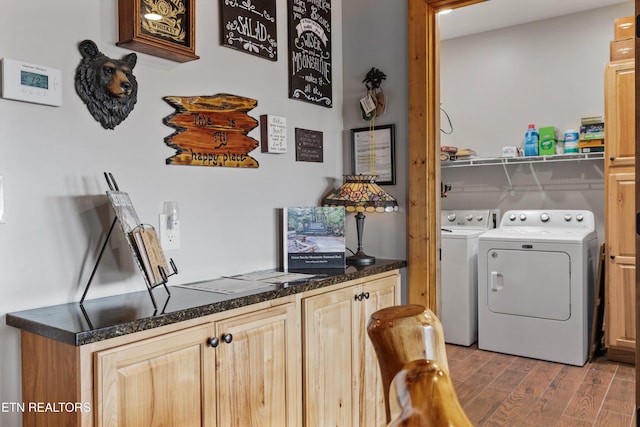 laundry area with light wood-type flooring, washing machine and dryer, and laundry area