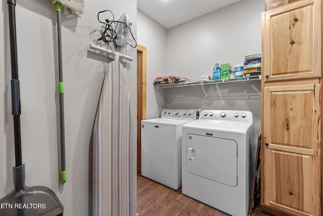 laundry area featuring laundry area, wood finished floors, and separate washer and dryer