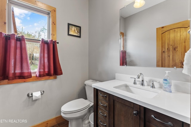half bathroom featuring toilet and vanity