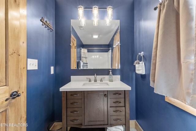 bathroom with vanity and baseboards