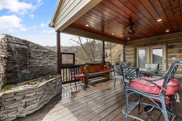 deck featuring outdoor dining space and ceiling fan