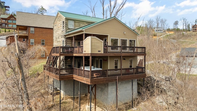 rear view of property with a wooden deck