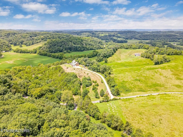 drone / aerial view with a wooded view