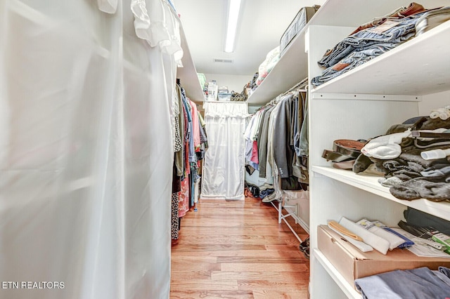 walk in closet with wood finished floors and visible vents