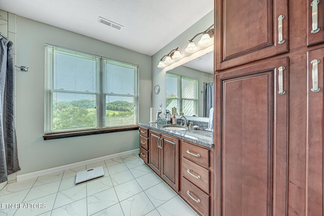 bathroom with vanity, baseboards, and visible vents