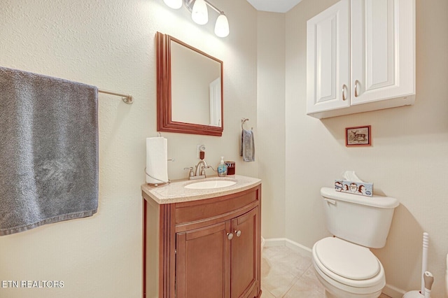 bathroom with tile patterned floors, baseboards, toilet, and vanity