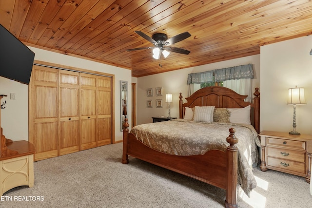 bedroom with ceiling fan, a closet, wooden ceiling, and carpet flooring