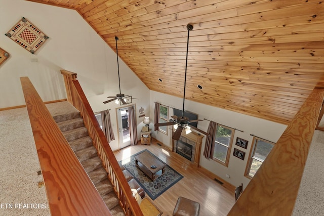 unfurnished living room featuring stairs, wood ceiling, visible vents, and high vaulted ceiling