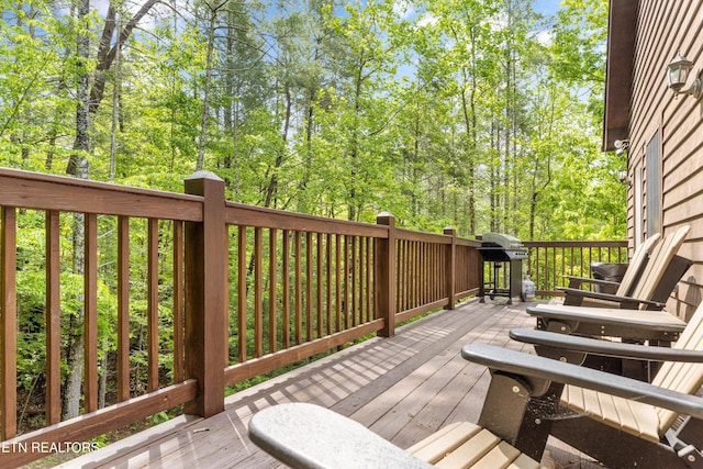 wooden deck with a grill