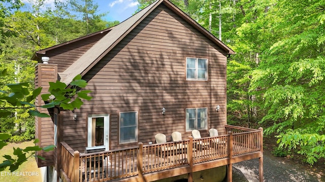 rear view of property with a wooden deck