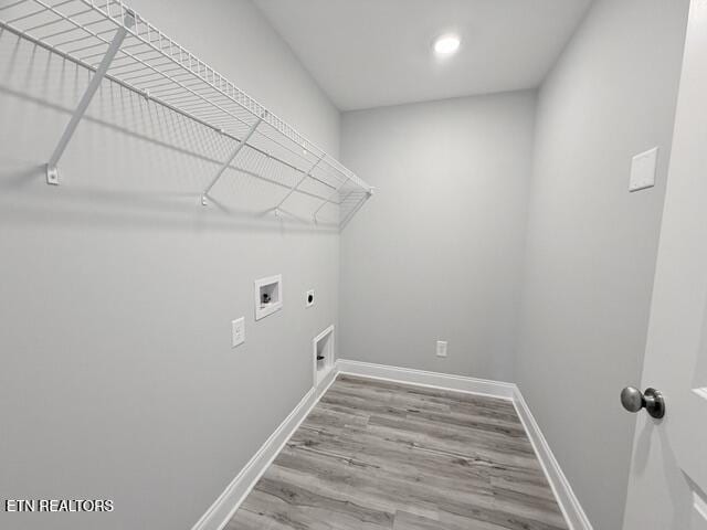 washroom featuring wood finished floors, baseboards, hookup for an electric dryer, laundry area, and washer hookup