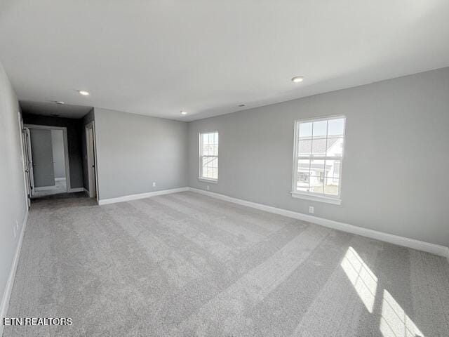 empty room with recessed lighting, baseboards, and light colored carpet