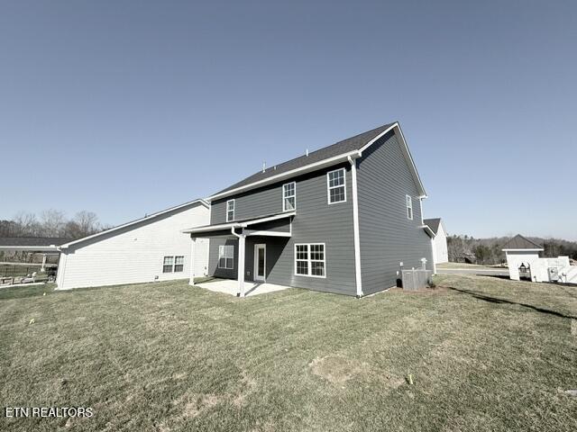 back of property with a patio, a yard, and central AC unit