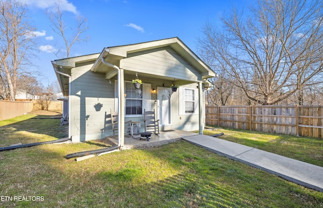 exterior space featuring a front lawn and fence