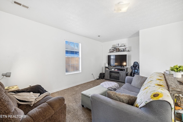 carpeted living room featuring visible vents, baseboards, and a textured ceiling