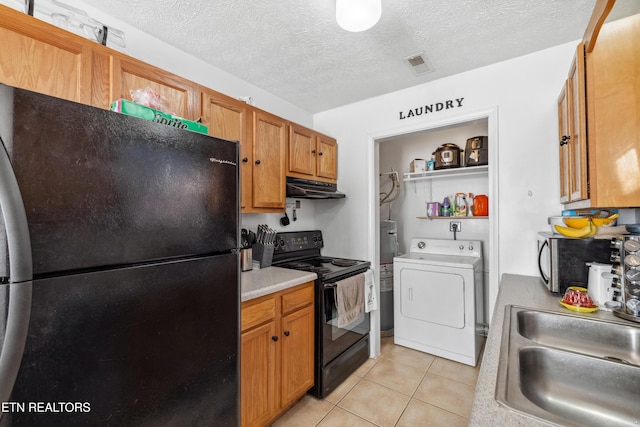 kitchen with washer / dryer, a sink, black appliances, light countertops, and under cabinet range hood