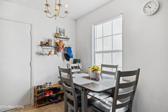 dining area with an inviting chandelier and light tile patterned floors