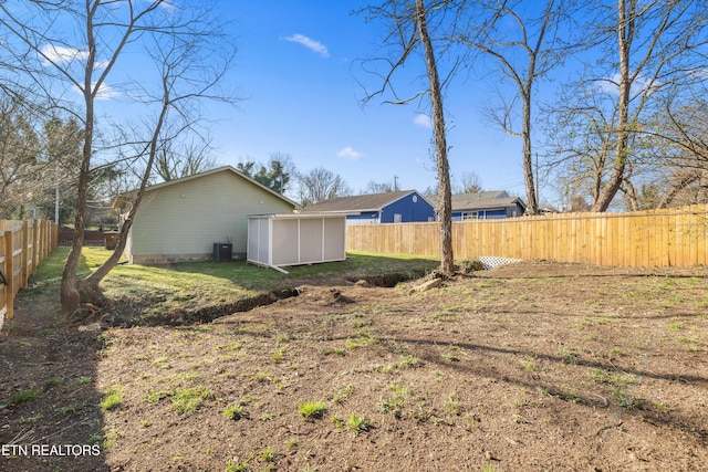 view of yard featuring an outbuilding and a fenced backyard