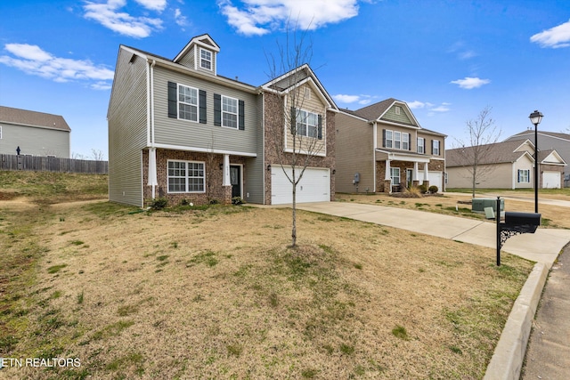 view of front of property with brick siding, a front lawn, fence, concrete driveway, and an attached garage