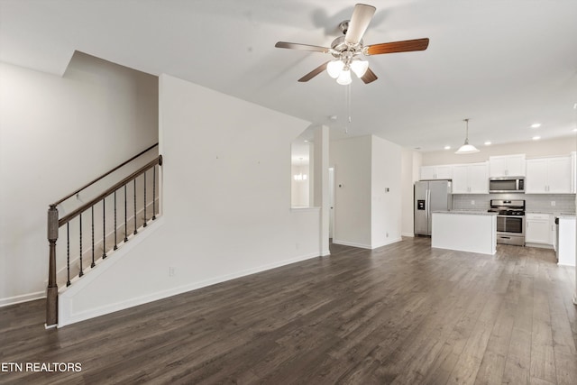 unfurnished living room featuring baseboards, dark wood finished floors, stairway, recessed lighting, and a ceiling fan