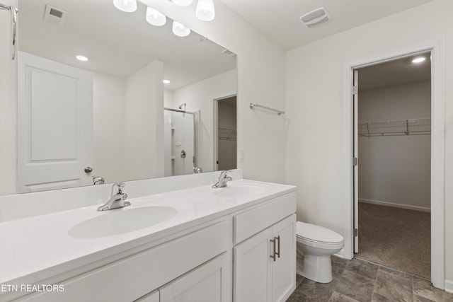 full bathroom with a shower stall, toilet, visible vents, and a sink