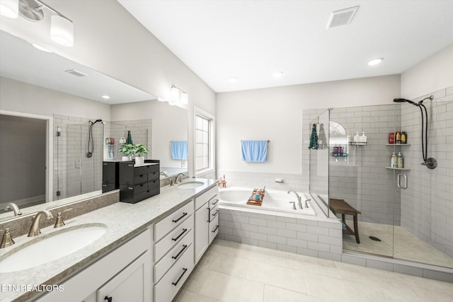 bathroom featuring a sink, visible vents, a stall shower, and a bath