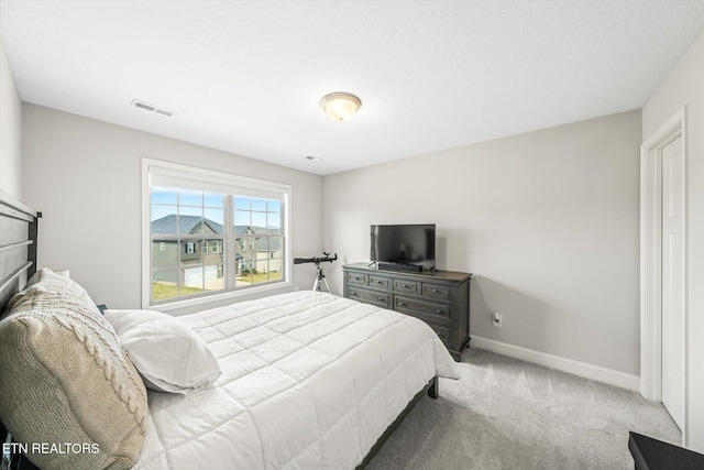 bedroom featuring visible vents, carpet flooring, and baseboards