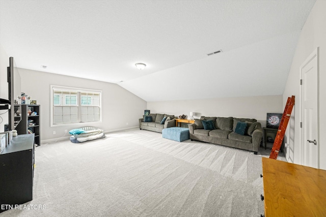 living area featuring visible vents, baseboards, lofted ceiling, and carpet floors