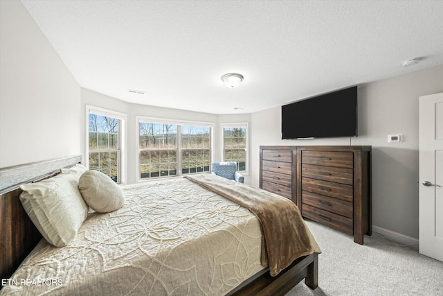 carpeted bedroom featuring baseboards and visible vents