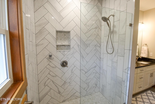 bathroom featuring vanity and a tile shower