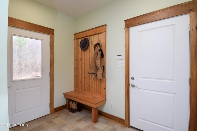 mudroom with baseboards and light floors