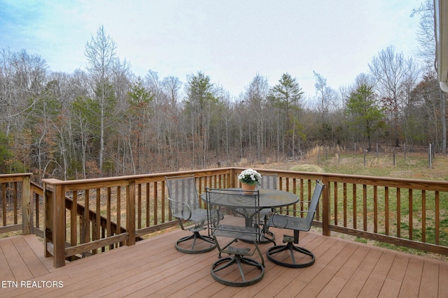 wooden terrace with outdoor dining space