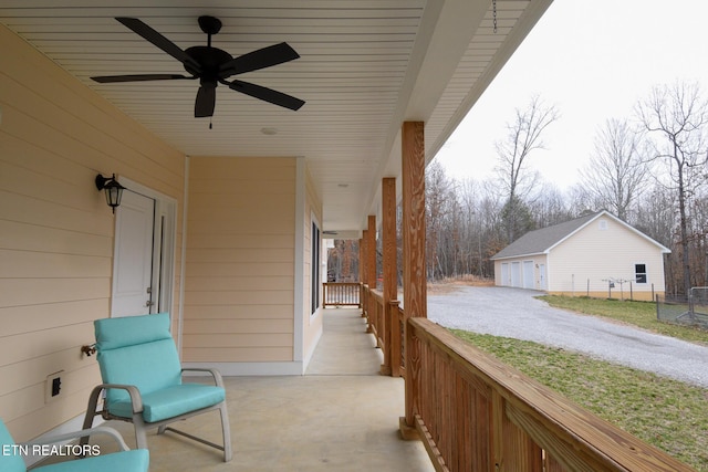 view of patio / terrace with an outdoor structure, a ceiling fan, and fence