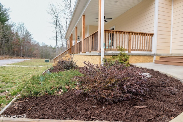 view of side of home with a porch and a ceiling fan