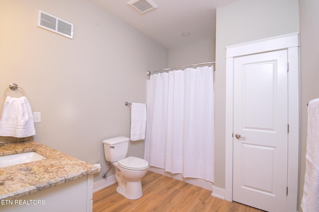 bathroom featuring visible vents, curtained shower, toilet, and wood finished floors