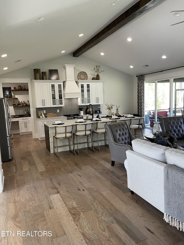 living room featuring dark wood-type flooring, vaulted ceiling with beams, and recessed lighting