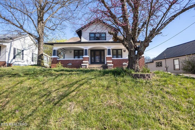 717 N Charles Seivers Blvd, Clinton, TN 37716 - view of front of house with a porch, a front lawn, french doors, and brick siding