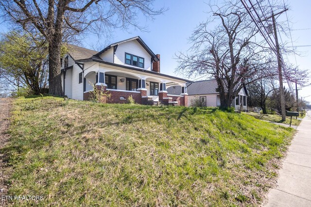 717 N Charles Seivers Blvd, Clinton, TN 37716 - bungalow with brick siding, a porch, and a chimney