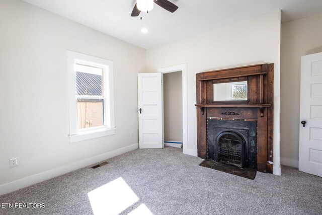 717 N Charles Seivers Blvd, Clinton, TN 37716 - unfurnished living room featuring a ceiling fan, a fireplace with flush hearth, carpet floors, visible vents, and baseboards
