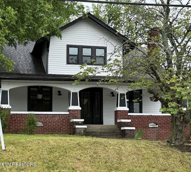 717 N Charles Seivers Blvd, Clinton, TN 37716 - view of front facade featuring covered porch, a shingled roof, a front lawn, and brick siding