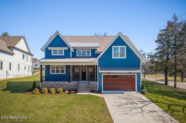 view of front facade with driveway, a front lawn, a standing seam roof, covered porch, and a garage