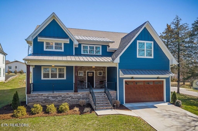 view of front facade with driveway, a standing seam roof, an attached garage, covered porch, and board and batten siding