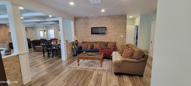 living room with beam ceiling, recessed lighting, wood finished floors, and ornate columns