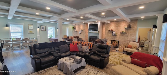 living room featuring a fireplace, beamed ceiling, wood finished floors, and coffered ceiling