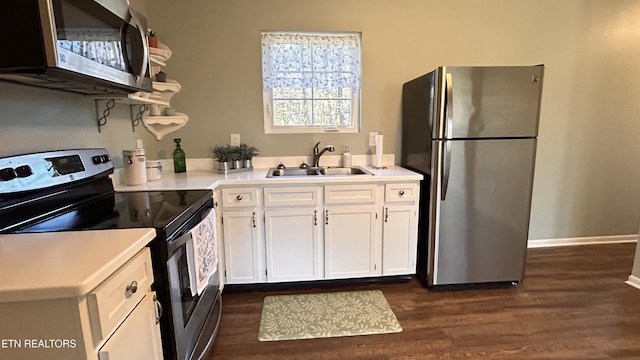 kitchen with a sink, open shelves, stainless steel appliances, white cabinets, and light countertops