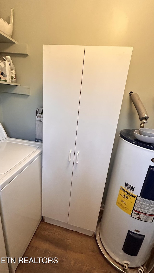 laundry area featuring laundry area, washer / dryer, electric water heater, and wood finished floors